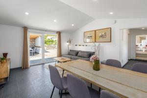a living room with a table and a couch at House Prenc in Pazin