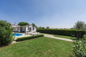 a yard with a swimming pool and a house at House Prenc in Pazin