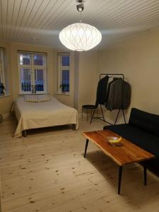 a bedroom with a bed and a table and a couch at Nybo House in Præstø