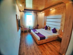 a bedroom with a large bed in a wooden room at Hans Cottage in Shimla