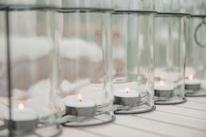 a row of glass vases with candles on a table at Ferienbungalow Ochsenkopf in Gefrees