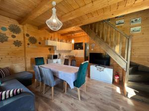 a dining room and kitchen with a table and chairs at Domek Twórczy Kąt in Święta Katarzyna +28 photos
