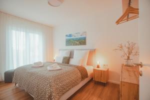 a bedroom with a bed with two towels on it at Ferienbungalow Ochsenkopf in Gefrees +22 photos