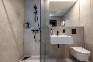 a bathroom with a toilet and a sink and a shower at Thon Hotel Andrikken in Andenes +63 photos
