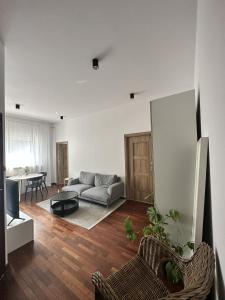 a living room with a couch and a table at Villa Masoneria in Łódź +11 photos