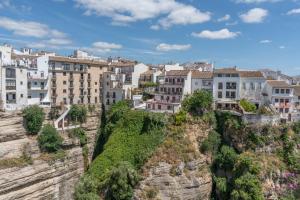 a city on top of a mountain with buildings at Apartamento Casa Sol Ronda in Ronda