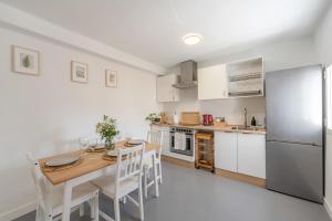 a kitchen with a table and chairs and a refrigerator at Apartamento Casa Sol Ronda in Ronda