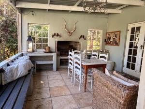 a kitchen with a table and chairs and a dining room at Almond Cottage Bed & Breakfast in Somerset West