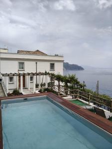 a swimming pool with a view of the water at Dimora de Feo in Amalfi