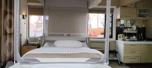 a bedroom with a canopy bed in a kitchen at Mitra @Guesthouse B28-S in Batam Center