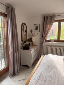 a bedroom with a bed and a mirror and a dresser at Apartment Ape Maja in Bad Wiessee