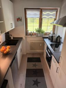 a kitchen with a bowl of fruit on the counter at Apartment Ape Maja in Bad Wiessee +65 photos