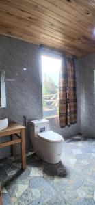 a bathroom with a toilet and a window at Luna Valley Homestay in Sapa