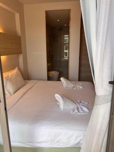 a bedroom with a bed with white towels on it at Coconut Studio Aonang in Ao Nang Beach