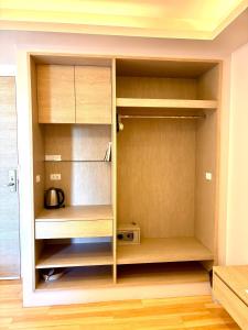 a closet with wooden shelves in a room at Coconut Studio Aonang in Ao Nang Beach