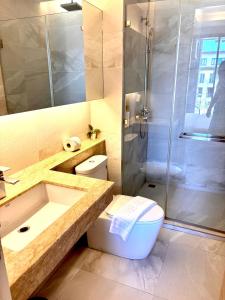 a bathroom with a shower and a toilet and a sink at Coconut Studio Aonang in Ao Nang Beach +3 photos