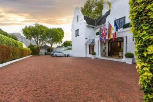 a brick driveway in front of a white building at The Claremont Boutique Hotel in Cape Town