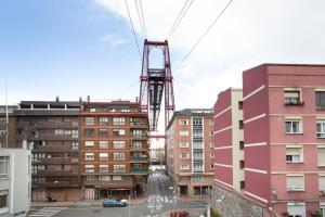 a crane in the middle of some buildings at Urbil Puente Colgante in Portugalete