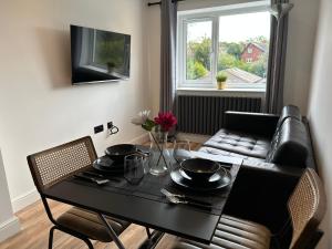 a living room with a table and a couch at Roundhay Residences in Moortown