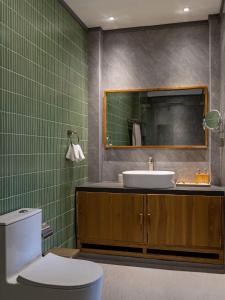 a bathroom with a sink and a toilet and a mirror at Island Ufaa Dharavandhoo in Dharavandhoo +27 photos