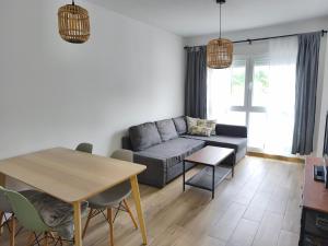 a living room with a couch and a table at Apartamentos DEVA in Unquera