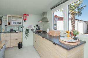a kitchen with a island with a counter top at Wonderful chalet in De Haan in De Haan