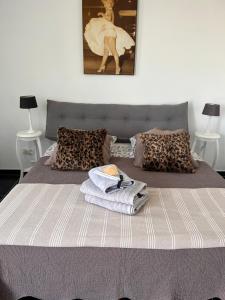 a bedroom with a bed with towels on it at la ferme au bois dormant in Wemaers-Cappel