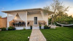 a home with a gazebo in a yard at Olive holiday home in Laganas