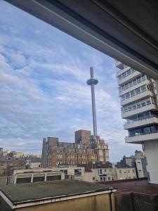 a view of a city with a cross in the distance at Brighton West Pier flat in Brighton & Hove
