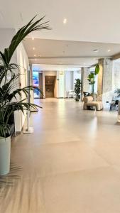a large lobby with plants in a building at Cristal Hotel Palermo in Palermo
