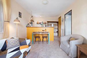 a living room with a couch and a table at Gite La Forge in Le Buisson de Cadouin +14 photos