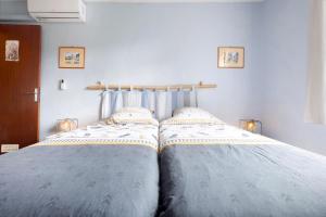 a bedroom with a bed with two pillows on it at Gite La Forge in Le Buisson de Cadouin