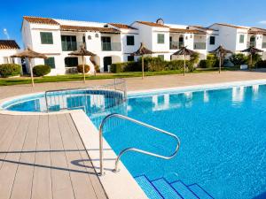 a swimming pool in front of a villa at Cala Porter Brise Marine in Cala en Porter