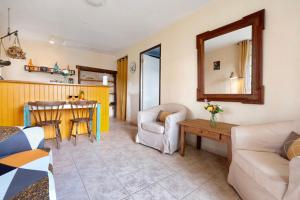 a living room with a couch and a table at Gite La Forge in Le Buisson de Cadouin