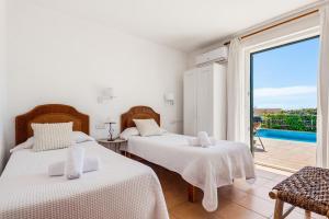 a bedroom with two beds and a balcony at Villa Ana by Escape Home in Santo Tomás +28 photos