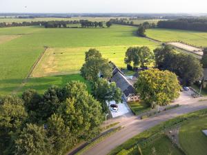 an aerial view of a house in the middle of a field at Grenzeloos in Doldersum