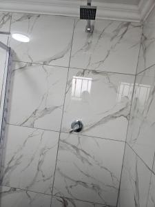 a white marble floor in a bathroom with a sink at Fullmoon Homes 9A in Edenvale +16 photos