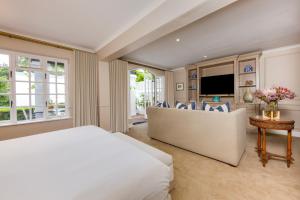 a bedroom with a bed and a living room at The Claremont Boutique Hotel in Cape Town