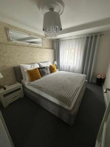 a bedroom with a large bed with yellow pillows at The Manor in Pilsen