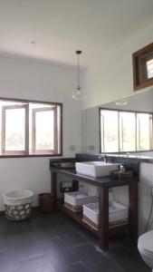 a bathroom with a sink and a toilet at บ้านริมดอย แม่ริม in Ban Mae Raem +58 photos