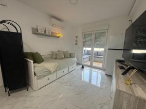 a living room with a couch and a television at Estudio Cuidad Quesada in Rojales