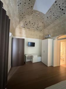 a room with a table and a tv on a ceiling at Antico castello BeB in Altamura