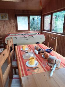 a table with a surfboard on top of it at Chambres IM-BERG in Metzeral +24 photos