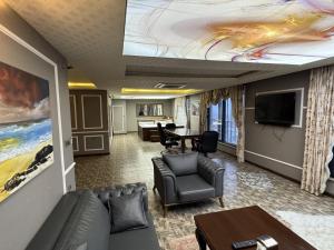 a living room with a couch and a flat screen tv at Grand Ali'n Tokat in Tokat