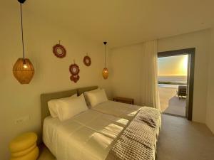 a bedroom with a bed and a view of the ocean at Fenia's Paradise Villa in Houlakia +38 photos