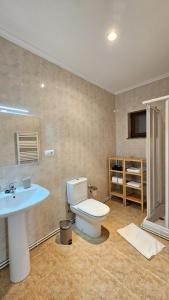 a bathroom with a toilet and a sink at 2 Hermanas 2 in Cudillero +19 photos