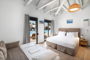 a bedroom with a bed and a couch at Almyra Holiday Village in Edipsos +45 photos