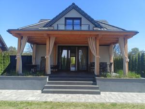 a house with a pavilion with a porch at Ucieknij do luksusu: Villa Wola in Krakow