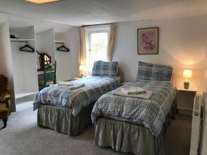 a bedroom with two beds and a window at Beachcombers in Craobh Haven +3 photos