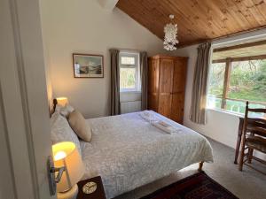 a bedroom with a bed and a window at Beachcombers in Craobh Haven